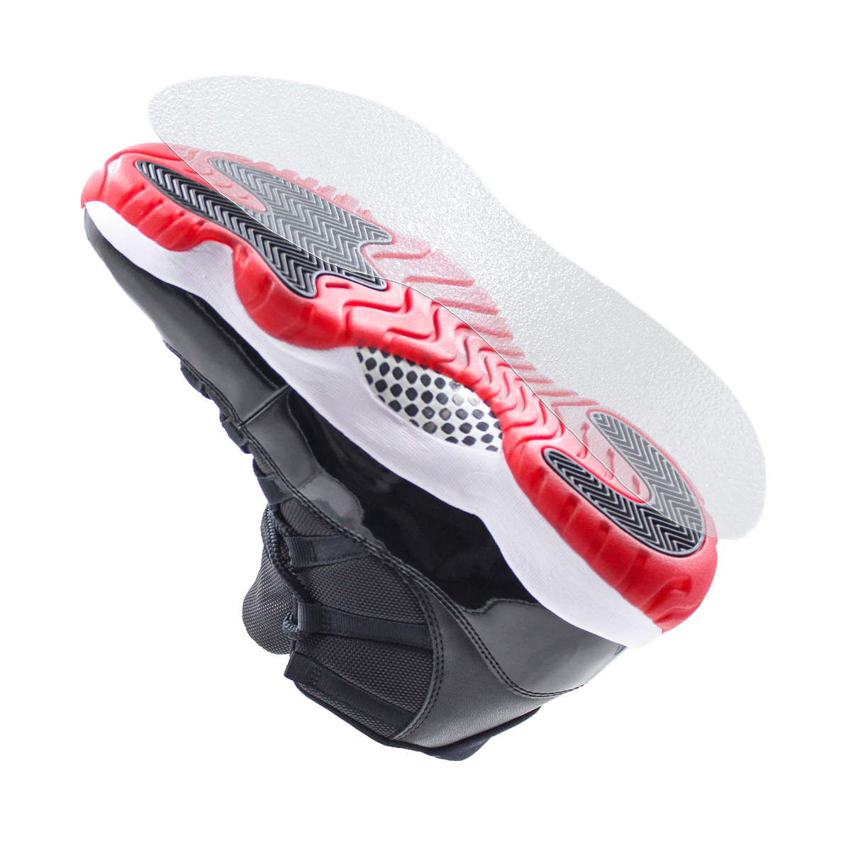 The Sole Guard Jordan 11 Traction Sole Guard 3 Pack, shown in black and red beneath the sneaker on a white background, adds protection and grip with durable traction sole protectors.