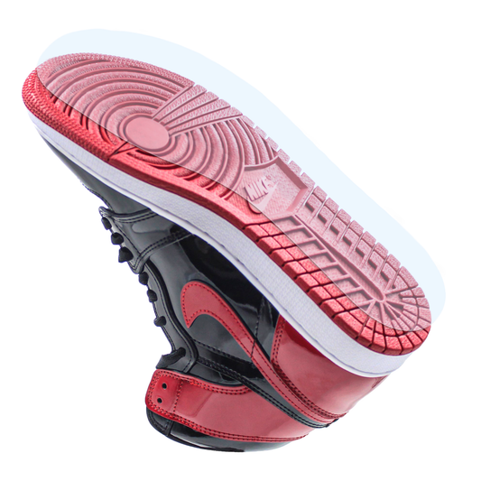 The Jordan 1 Sole Guard is shown from a low angle on a red-soled, red and black Air Jordan 1 sneaker, providing added durability.