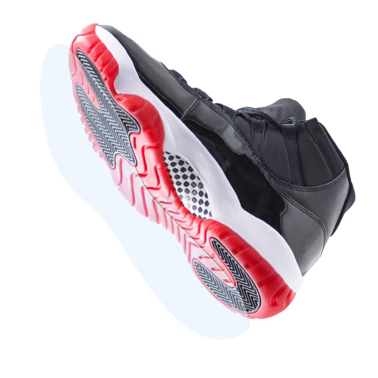 The Jordan 11 Sole Guard is shown from below, displaying its black upper and red-and-white sole against a white background—ideal for sneaker preservation enthusiasts or anyone looking to protect their Jordans.