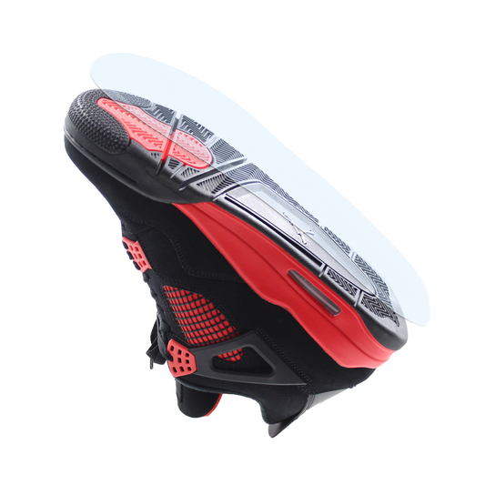 Black and red Jordan 4s sneaker viewed from below, showcasing the sole with a durable Jordan 4 Sole Guard and part of the upper against a white background.