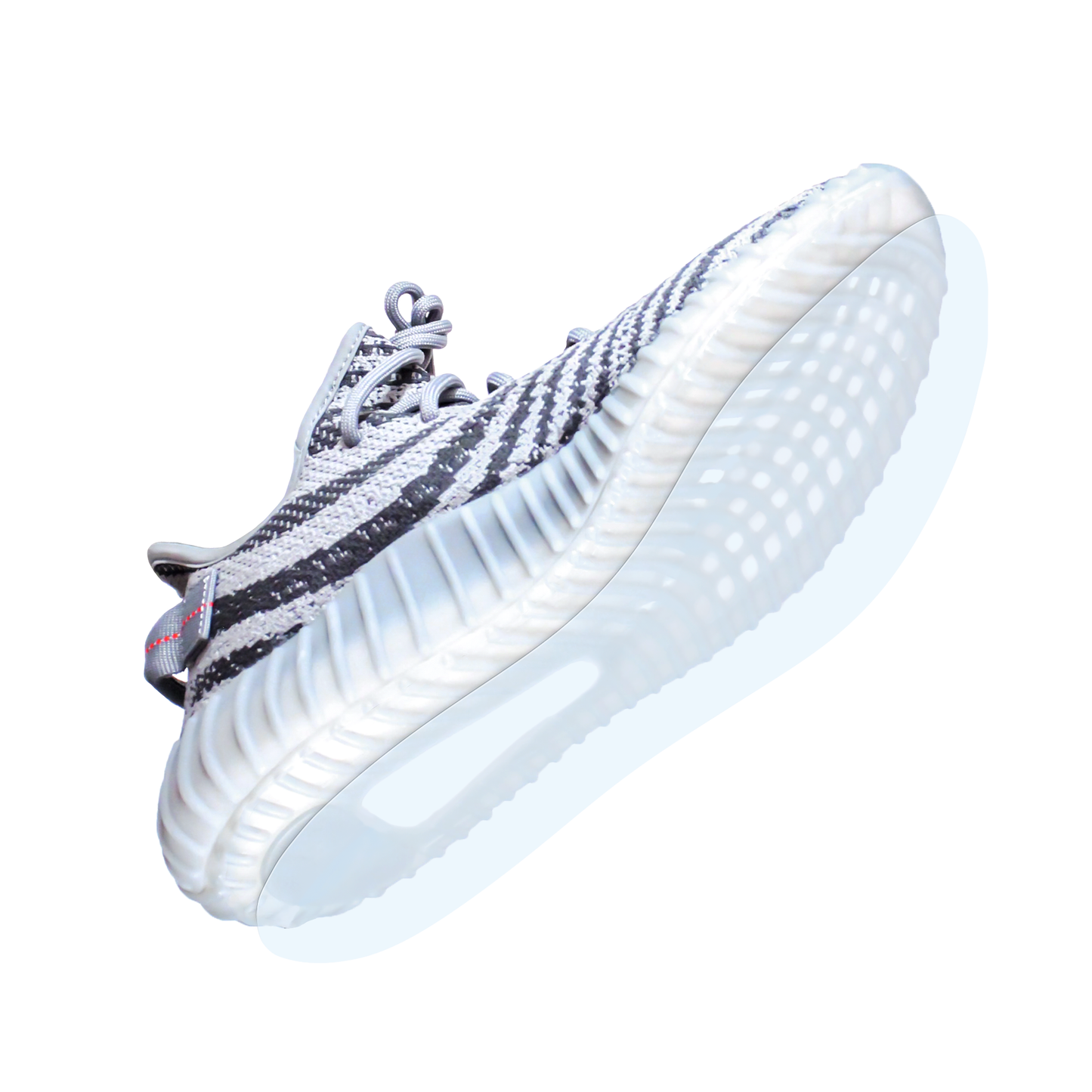 Gray and white athletic sneaker with a textured sole, viewed from underneath on a white background—compatible with the Yeezy Boost 350 Sole Guard for extra durability.