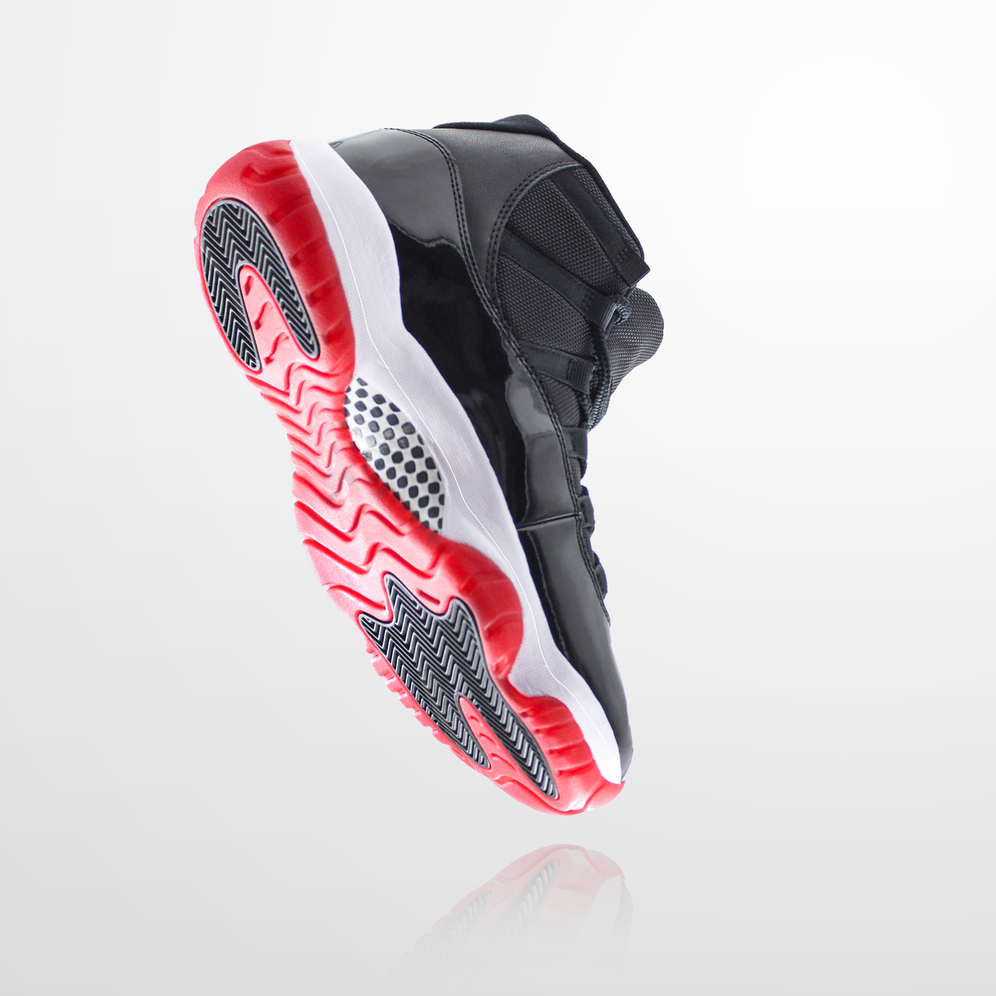 The Jordan 11 Sole Guard is a black high-top sneaker with a reflective upper and red and white sole, set against a plain background. It's perfect for fans of iconic styles who also need Sole Guard technology's durability for sneaker preservation.