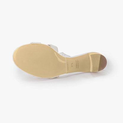 The Hermès Oasis Sandal Sole Guard 3x Pack enhances the Oasis Sandal’s chic white strap and tan sole. Elevating style with a block heel, its design is seamlessly complemented by invisible sole protectors for added durability.