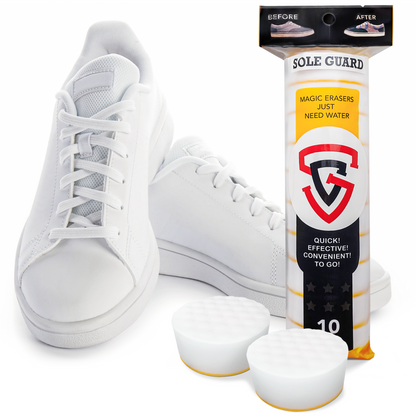 Two white sneakers rest beside a Sole Guard Sneaker Eraser package, including two round sponges for impeccable care.