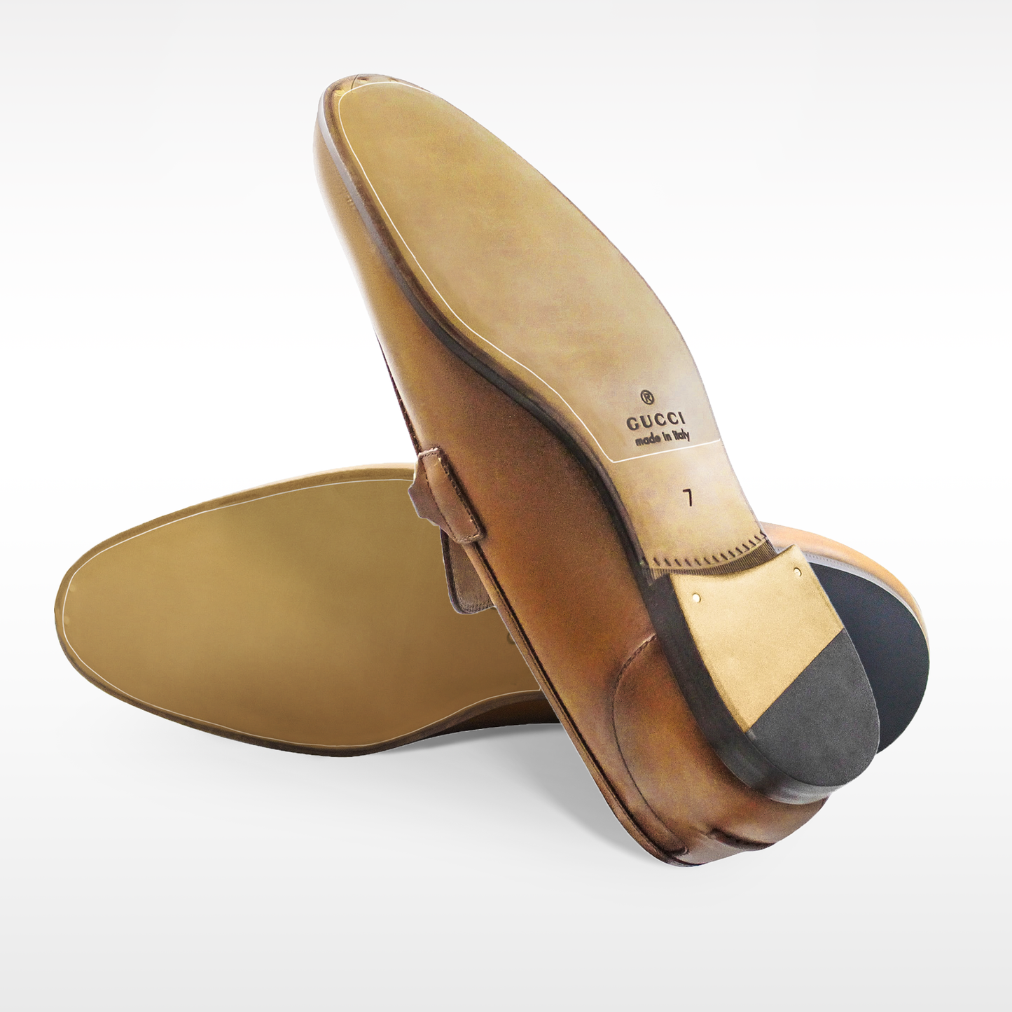 Brown leather Gucci loafers displayed on a white background, emphasizing the crafted soles and uppers. Extend their lifespan with the Gucci Loafers Sole Guard 3x Pack for ultimate protection.