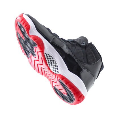 The Jordan 11 Sole Guard, a high-top sneaker in black and red, is depicted from a low angle to emphasize its textured sole.